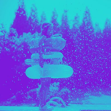 woman with multiple pool floaties being snowed on