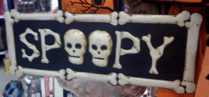 picture of Halloween decoration with the word spooky spelled as spooky with two skulls as the letter O