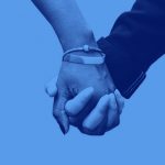 image of two hands holding each other on a blue blackground.