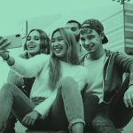 Group of teens taking a selfie, teal filter