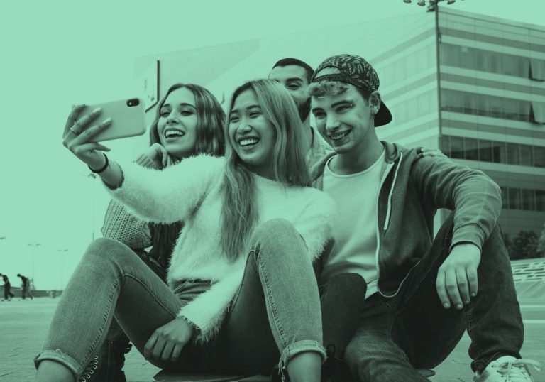 Group of teens taking a selfie, teal filter
