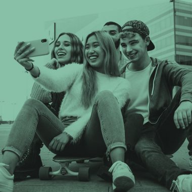 Group of teens taking a selfie, teal filter