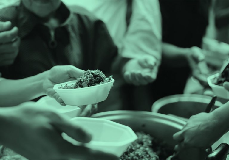 Close-up of serving food to a group, teal filter