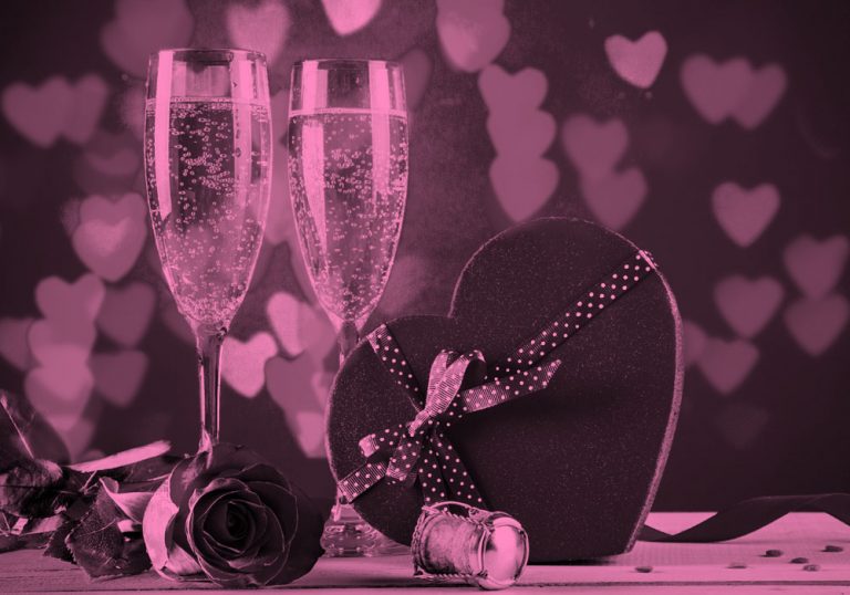 2 champagne glasses and a heart-shaped box of chocolates, pink filter