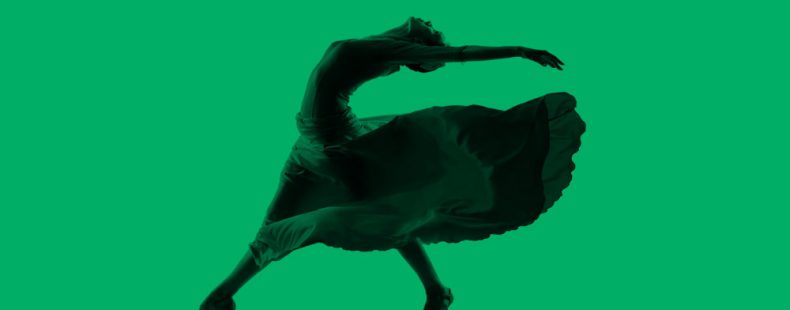 Latin dancer striking a pose, green background.