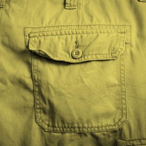 close-up of back pocket of pants, yellow filter.