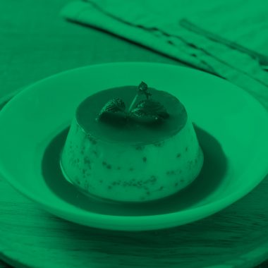 photo of caramel custard pudding with mint, green filter.