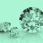 3 diamonds of different sizes, their reflections visible on the tabletop, teal filter.