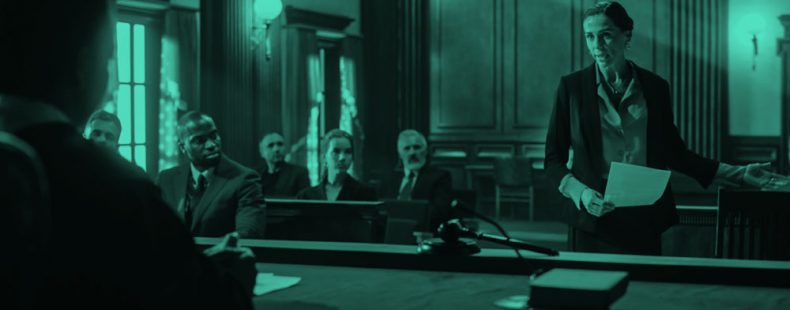 female lawyer speaking to judge in a courtroom, teal filter.