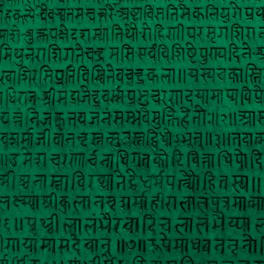 Background with ancient sanskrit text etched into a stone tablet, green filter.