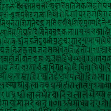 Background with ancient sanskrit text etched into a stone tablet, green filter.