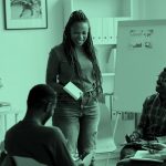 Multi-ethnic group of people talking in an office.