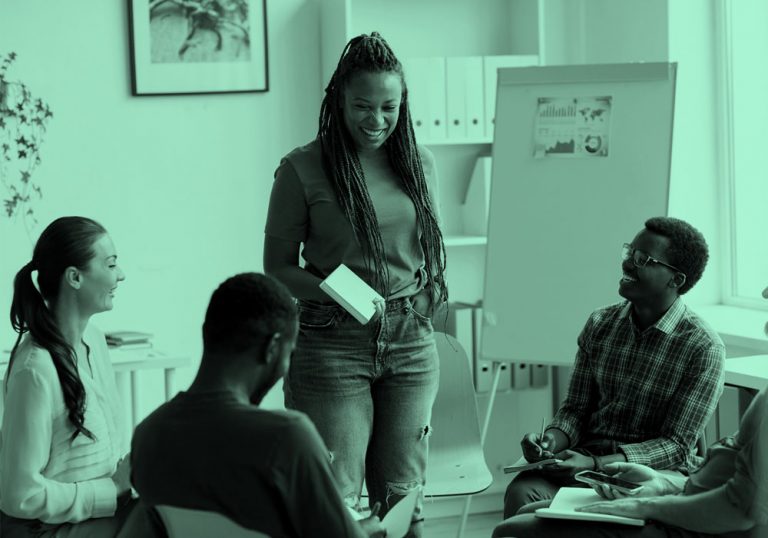Multi-ethnic group of people talking in an office.