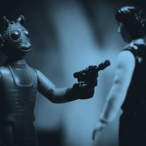 toy Star Wars figures showing a bounty hunter and Han Solo, in blue filter.