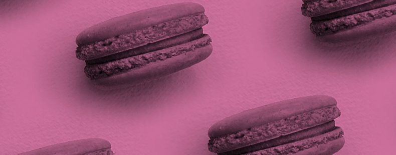 macaron cookies on a pink background