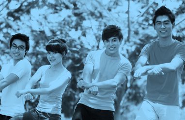 Photo of four young friends doing the "Gangnam Style" dance, blue filter.