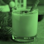 glass of eggnog with cinnamon stick