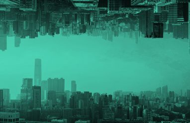image of a cityscape reflected upon itself, in teal filter.
