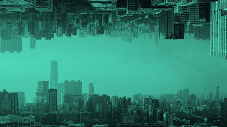 image of a cityscape reflected upon itself, in teal filter.
