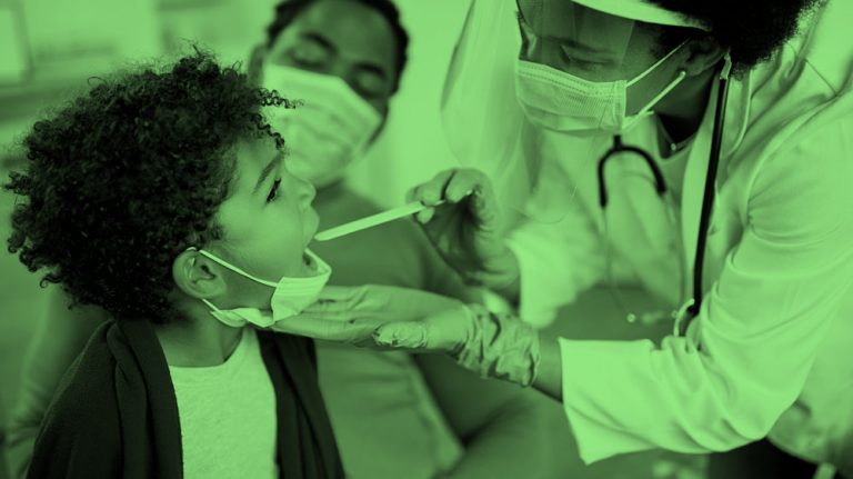 A doctor examining a child patient's mouth with parent sitting on the side, green filter.