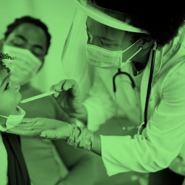 A doctor examining a child patient's mouth with parent sitting on the side, green filter.
