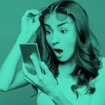 image of shocked woman looking at her phone, teal filter.