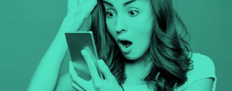 image of shocked woman looking at her phone, teal filter.