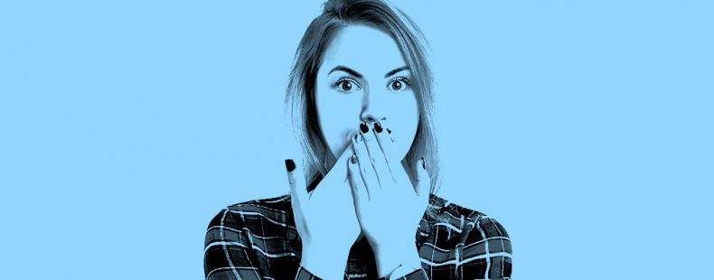 image of woman covering up her mouth with her hands, in a light blue filter.