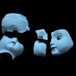 blue filtered image of broken pieces of porcelain doll's head, on black background.