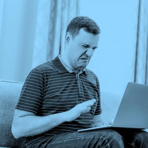 man looking disgusted by something on his computer