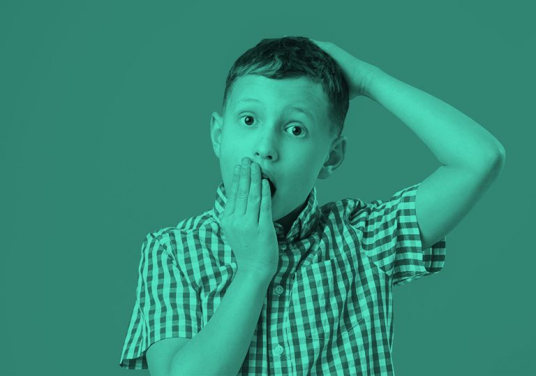 boy with hand over mouth