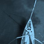 top down image of boat, blue filter