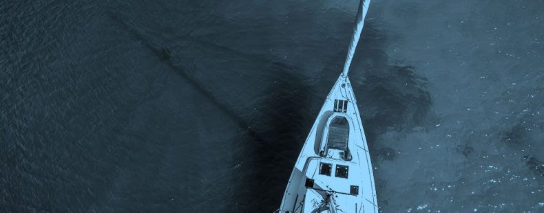 top down image of boat, blue filter