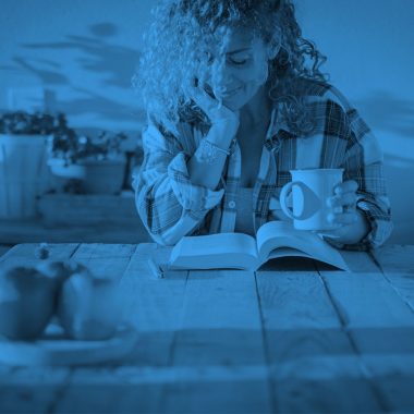 woman reading book, farm house, blue filter