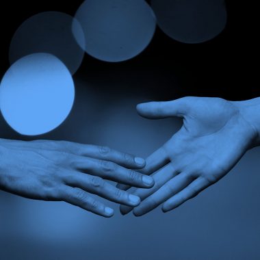 hands touching; blue filter