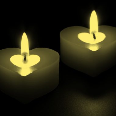 two heart-shaped candles, yellow filter