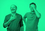 older and younger men laughing; green filter