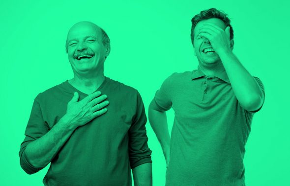 older and younger men laughing; green filter