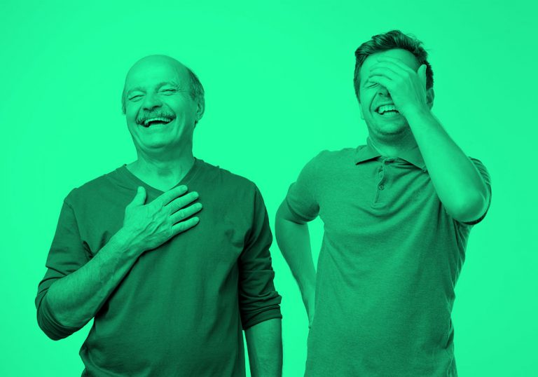 older and younger men laughing; green filter