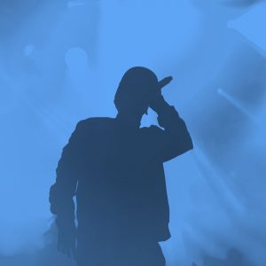 hip hop artist on stage; blue filter