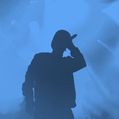 hip hop artist on stage; blue filter