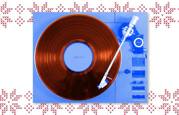 vinyl player, blue, on holiday sweater print background